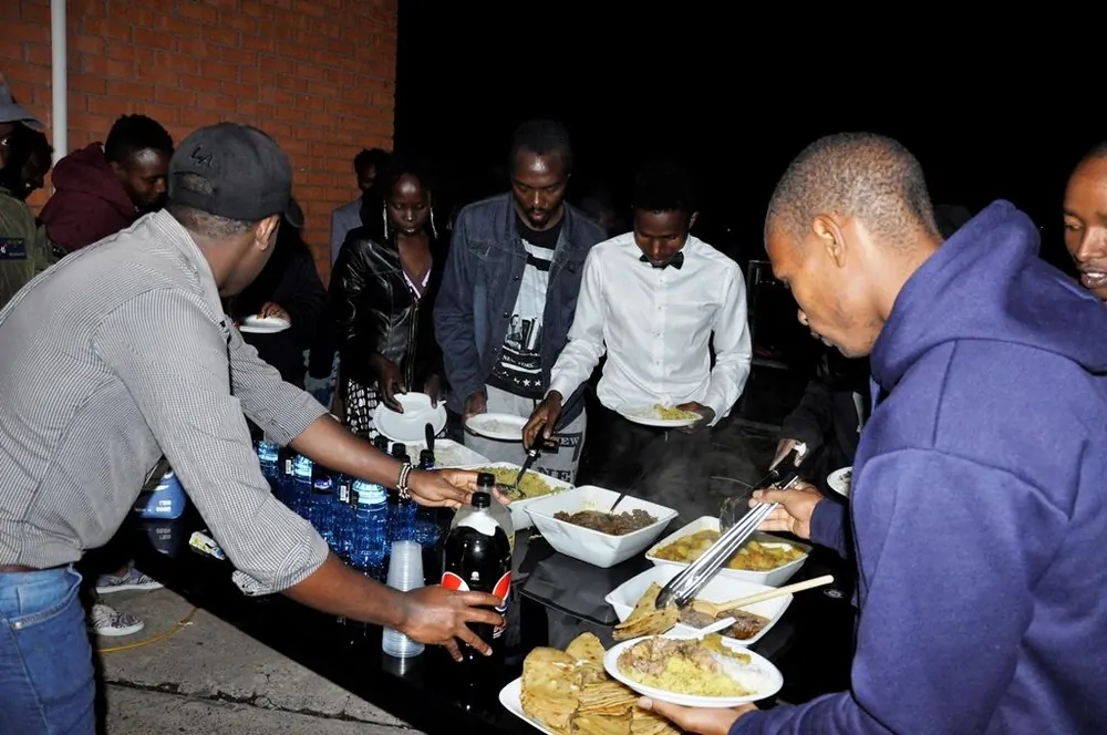 UKACA members sharing food at an evening gathering